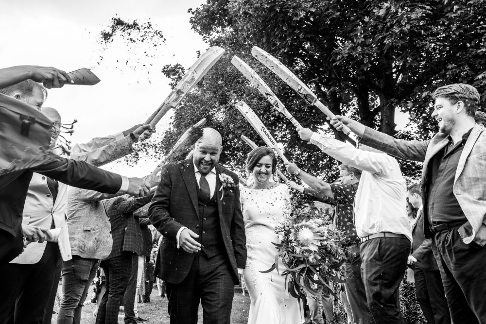 A bride and groom confetti run