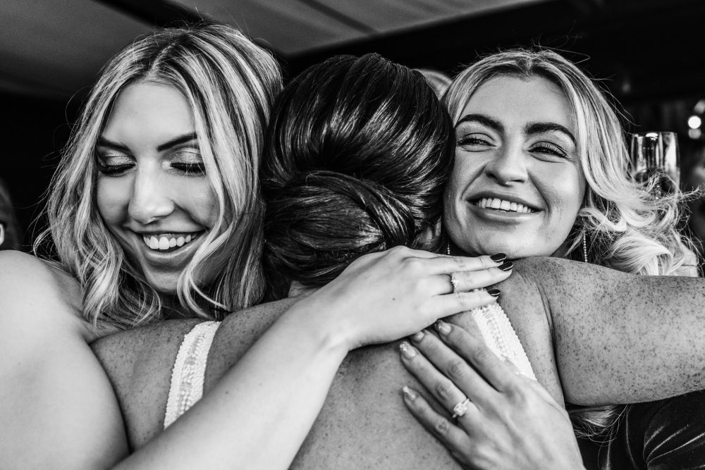 Three women hugging