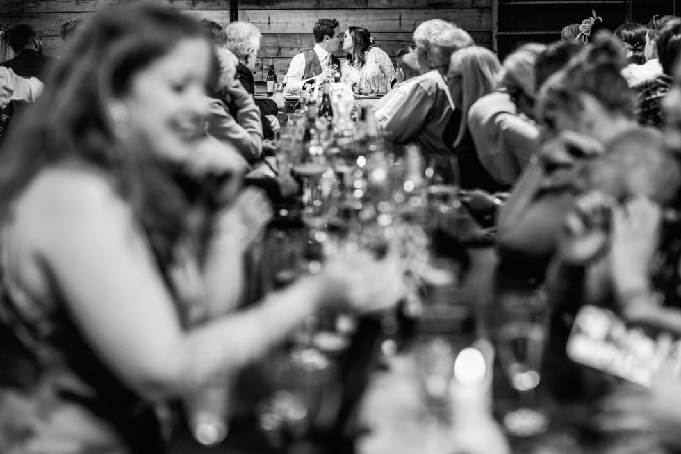 A couple Kiss, they are in focus while lots around them is out of focus.