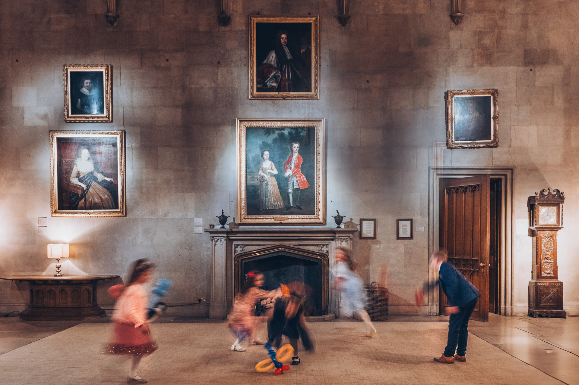 A young wedding guest plays with a bubble